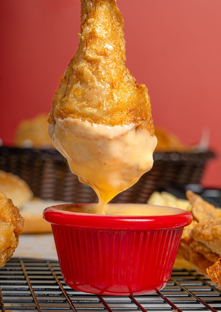 Dipping a broast leg into a creamy dip