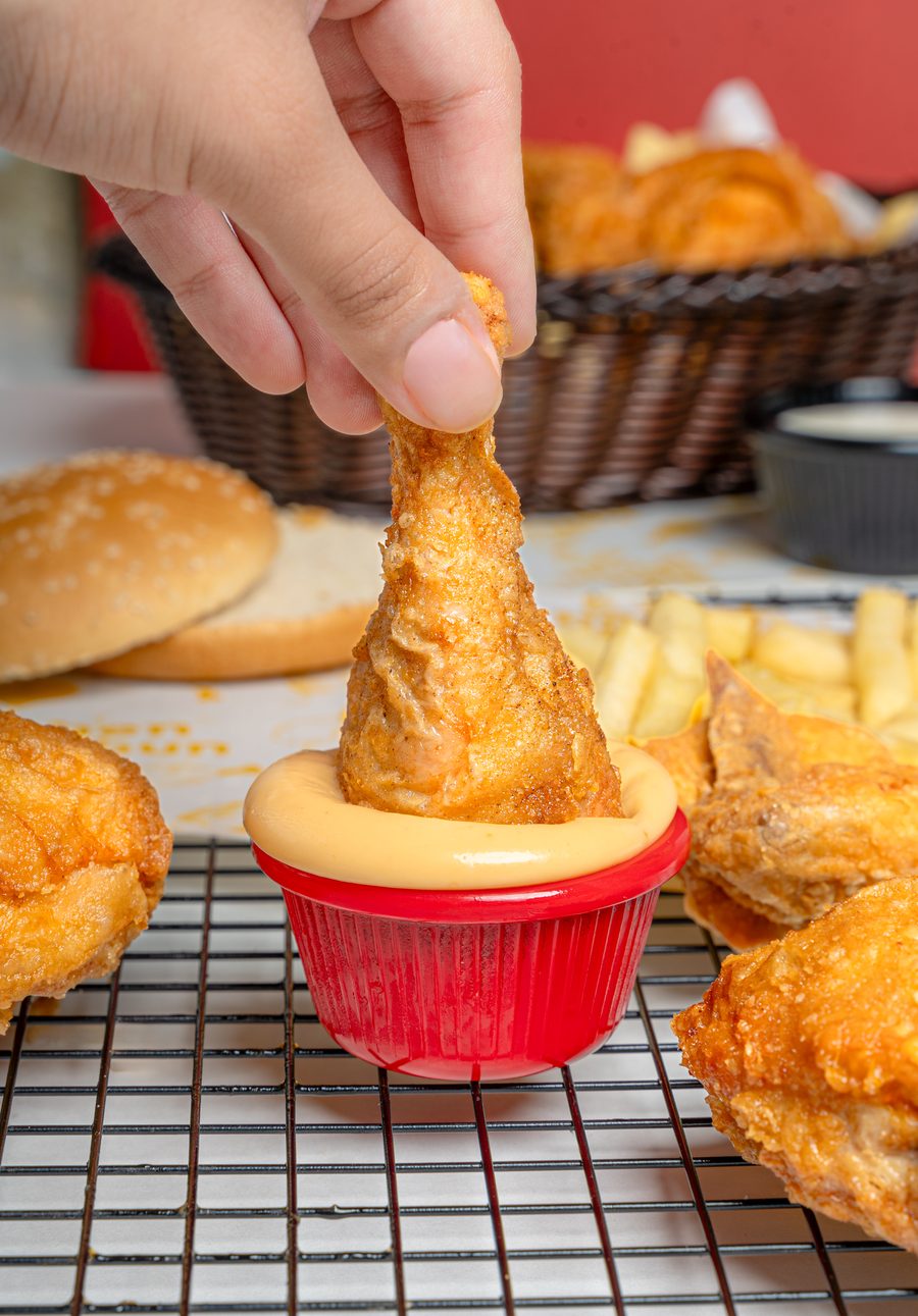 Hand dipping a broast leg